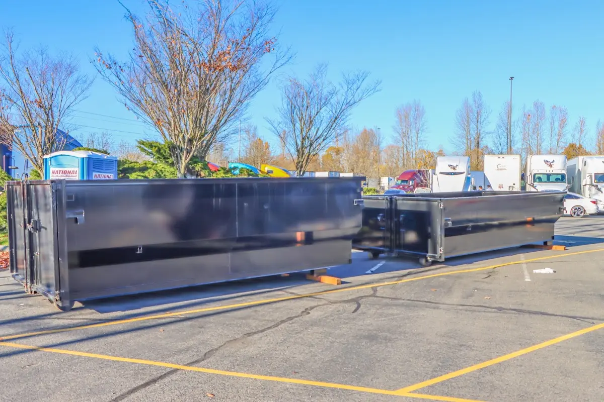 Professional dumpster rental service with roll-off container on residential driveway in Bellmead